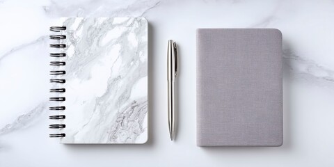 Notebook and pen flat lay on white marble surface