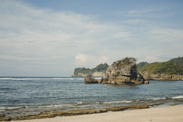 Panoramic View of Kondang Merak Beach, East Java, Indonesia with Rugged Rock Formations and Calm...