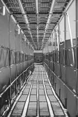 Monochrome Industrial Walkway into Construction Depths