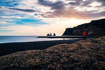 Scenic view of Reynisfjara black sand beach with Reynisdrangar sea rock stacks in the sunset at Iceland