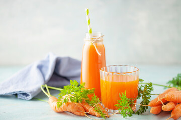 Fresh  carrot juice in glass bottle on a  wooden table