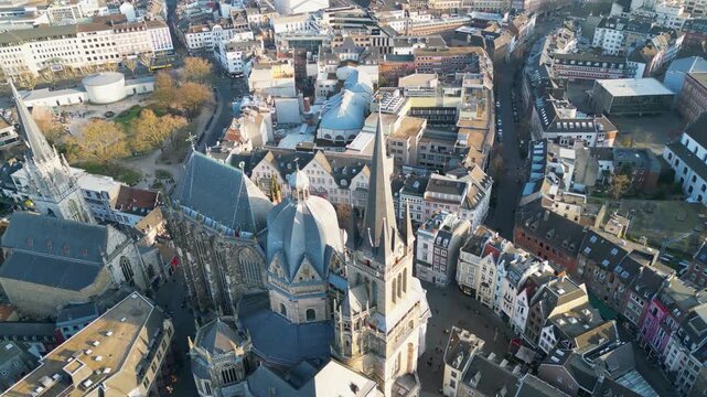 Aerial view of Aachen Cathedral and its spires amidst the city's architecture, creating a tapestry of textures and tones, Aachen, North Rhine-Westphalia, Germany.