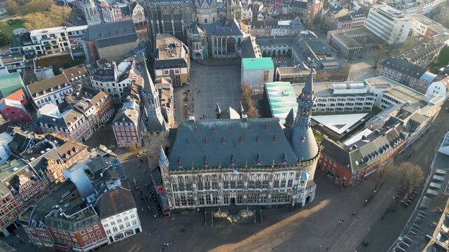 Aerial view of Aachen Rathaus, its dark tiled roof contrasting with the open market square and surrounding buildings, Aachen, North Rhine-Westphalia, Germany.