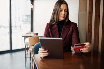 Woman using credit card to purchase online