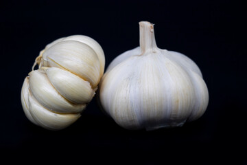 Fresh garlic isolated. Garlic bulbs with cloves on black background. White garlic bulb composition. With clipping path. Full depth of field