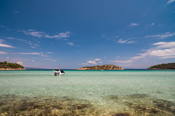 Fototapeta premium landscape with a boat on turquoise water at sea
