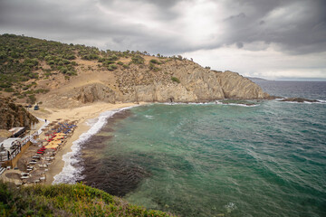 beautiful landscape with a beach at the sea and dramatic rain clouds