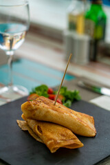 rolled omelette served on a stone plate