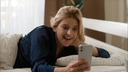 Surprised Caucasian woman wake up typing mobile phone winning at home sleepy winner lady checking notification smartphone morning shock happy female girl rejoicing success enjoy good news achievement