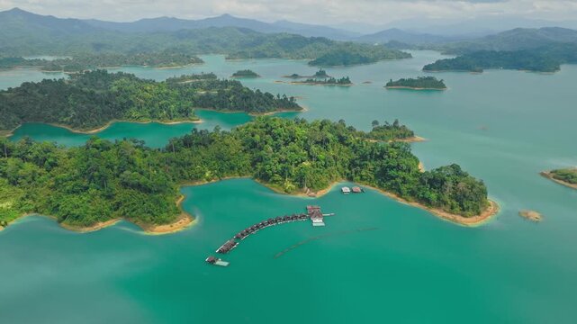 Aerial view of Khao Sok National Park, where lush green islands meet turquoise waters, creating a stunning contrast in Phanom District, Surat Thani, Thailand.