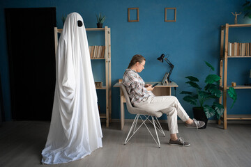 Concept of Life and death. afterlife, memory lost love. Male ghost in white sheet looking on his...