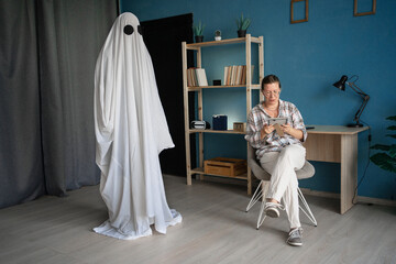 Life and death. afterlife and memory for lost love. woman sitting on chair crying looking old...