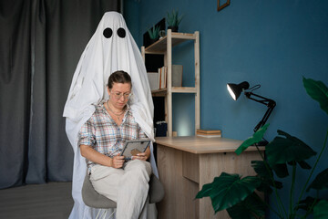 Life after death. depressed lonely young widow looking at old framed photo bored sitting on chair...