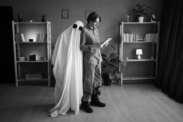 Concept of afterlife and memory for lost love. Depressed sad widower looking old photo while female...