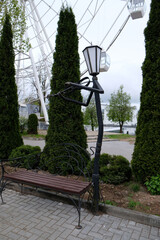 street lamp in the shape of a violinist near a bench