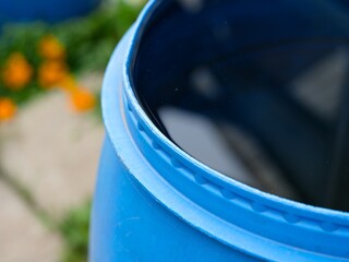 Close-up of a blue barrel full of water