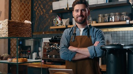 Happy Caucasian man guy barista working posing in cafeteria owner crossing arms employee smile restaurant male serving catering worker selling food store job small business success waiter profession
