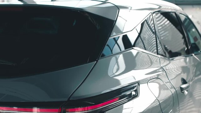 Sleek silver SUV parked indoors, showcasing modern design elements and reflections, highlighting automotive craftsmanship and innovation in a dealership setting