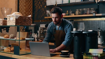 Glad Caucasian entrepreneur staff work in cafe waiter smile drink cup coffee energy beverage man...