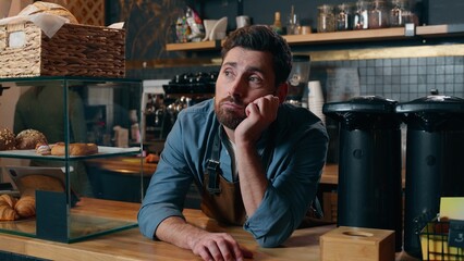 Frustrated Caucasian bartender man staff guy waiting clients in coffee shop bored employer working small business owner feeling stress cafeteria upset male barista no customers problem cafe difficulty