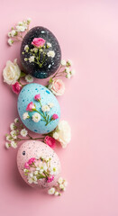 Decorated easter eggs with roses and gypsophila on pink background