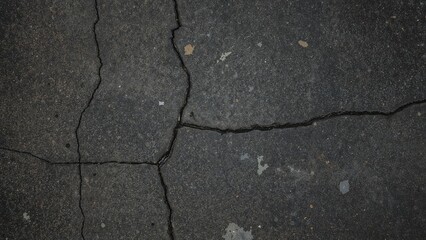 Obraz premium Close-up from Above of Worn Dark Gray Road Surface with Multiple Fissures