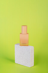 Cosmetic cream tube and skin care or sunscreen cosmetic with stylish propson green background.