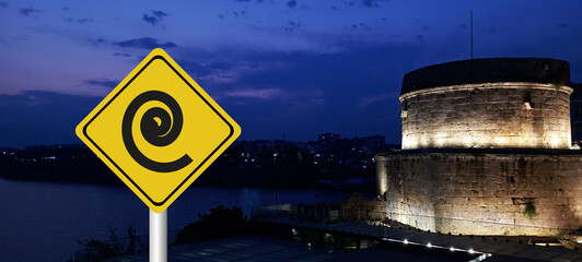 Hurricane season with symbol sign against a stormy background and copy space. dirty and angled sign...