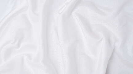White wrinkled fabric draped softly on a flat surface  
