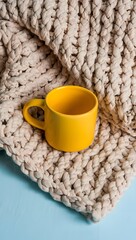 Yellow Mug on Cozy Knitted Blanket
