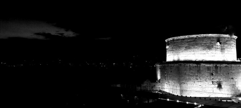 ALANYA, TURKEY - JULY 15, 2025: Shipyard (Tersane) and the ruins of a medieval fortress (Alanya Castle) on the mountainside