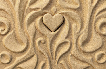 Heart shape surrounded by decorative patterns in sand texture  