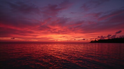 Deep red and purple twilight casting hues over the water