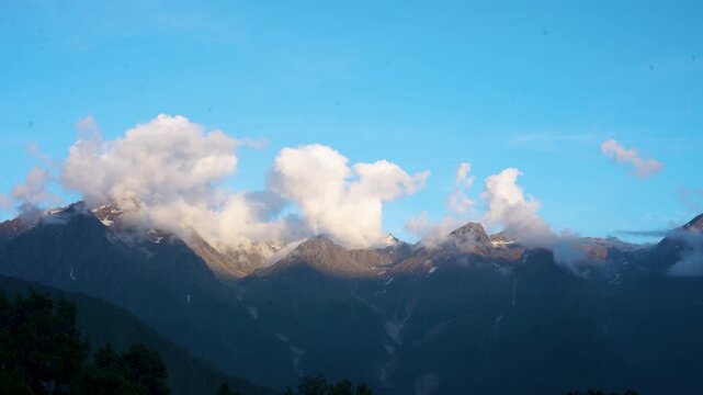 4K Timelapse of Himalayan mountains during sunset in Keylong, Himachal Pradesh, India. Clouds moving over mountains during sunset. Timelapse of clouds and mountains. Indian Himalayas.
