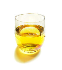 Transparent glass of plum wine with droplets and rainbow reflection on white background.