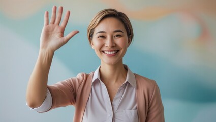 Smiling woman waving hello in front of pastel background