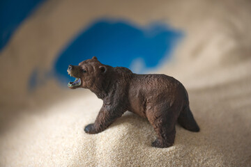The concept of psychology. Sand
therapy. A bear figurine in a blue sandbox.
Psychology. Therapy.