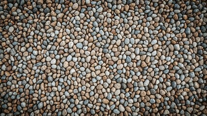 Textured background of small rounded stones viewed from above