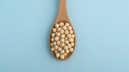 Flat Lay of Makhana in Wooden Spoon Isolated on Light Blue with Room for Text, Also Named Lotus Seed Pop or Euryale Ferox