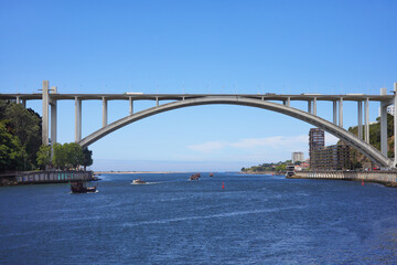Arrabida Bridge in Porto, Portugal, crosses the Douro River and connects Porto with Vila Nova de Gaia, view to the Atlantic Ocean with Copy space