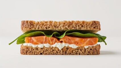 Cream cheese, spinach, and salmon sandwich captured in close-up with a white background and focused detail
