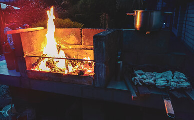 Light the grill make a fire for a chicken barbecue.