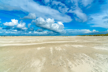 Just before a huge rain shower on Oosterend Beach Terschelling, this spectacle occurs with the light sandy beach and beautiful cloudy skies above it