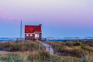 Photo of the Signal House on the highest dune of Terschelling with the morning mist between the...
