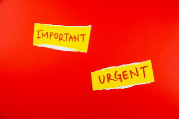 Yellow sticky notes with the words important and urgent on vibrant red background for effective communication and reminders in a professional or personal setting
