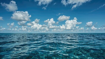 Fototapeta premium A dazzling sea view paired with a radiant sky dotted with clouds.