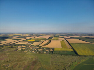 Overhead view of farmland with sharp geometric boundaries between fields, emphasizing agricultural...