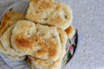 Traditional Bulgarian home made deep fried  patties  covered with sugar  оn rustic backgroud.Mekitsa or Mekica,  on wooden  rustic  background. Made of kneaded dough that is deep fried 