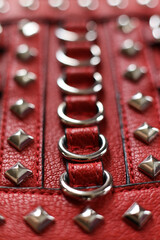 Red leather with silver rivets close-up macro photography