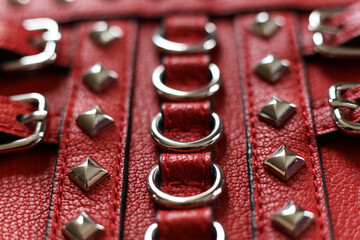 Red leather with silver rivets close-up macro photography